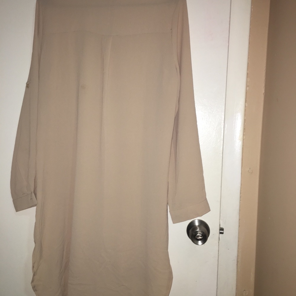 a creamlong sleeve dress with white beats on it